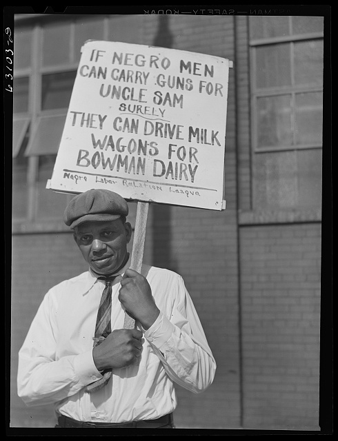 Man holding up a picket sign 